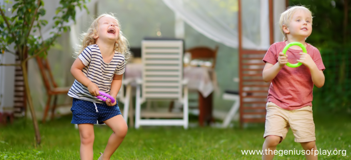 young girl and boy playing ring toss outdoors