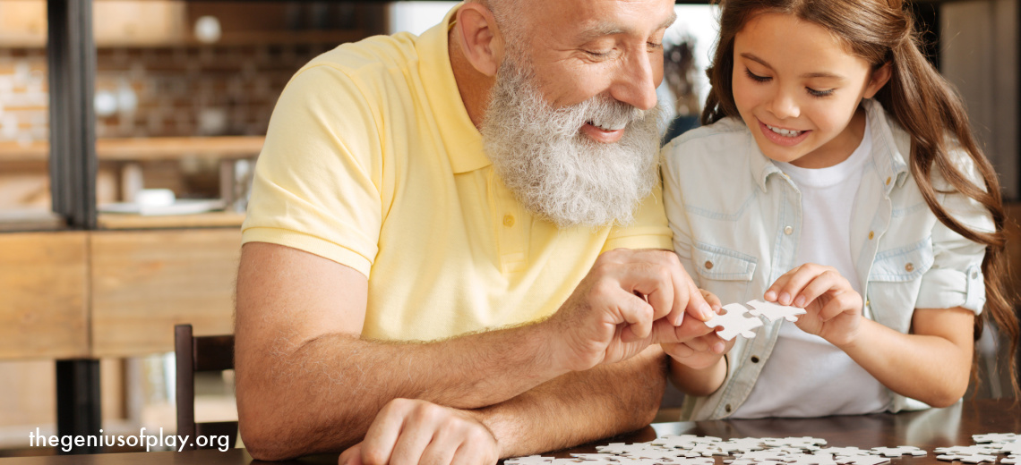 grandfather and granddaughter doing a jigsaw puzzle together