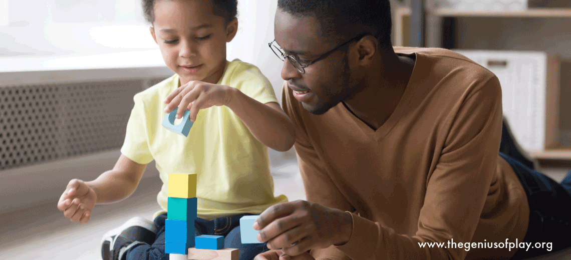 African American father and young son playing with colorful construction blocks